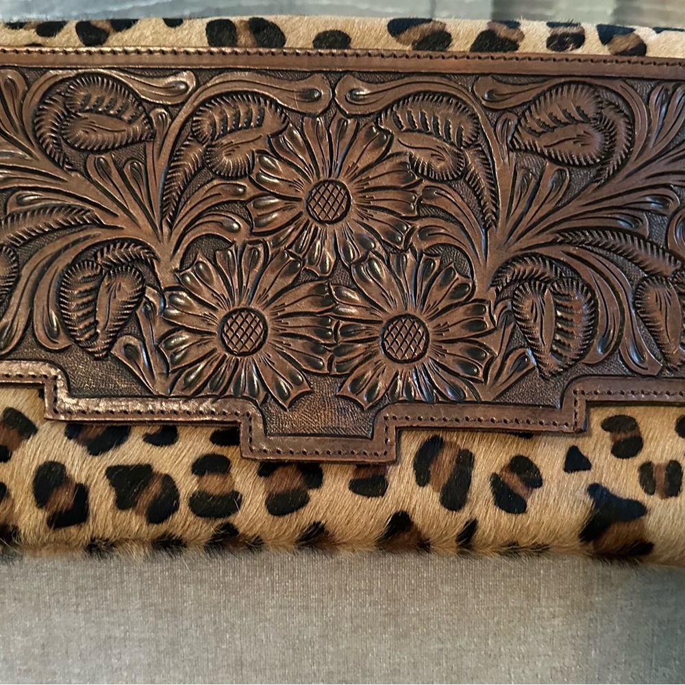 Leather/cowhide clutch purse w/strap.  Leather tassels.
